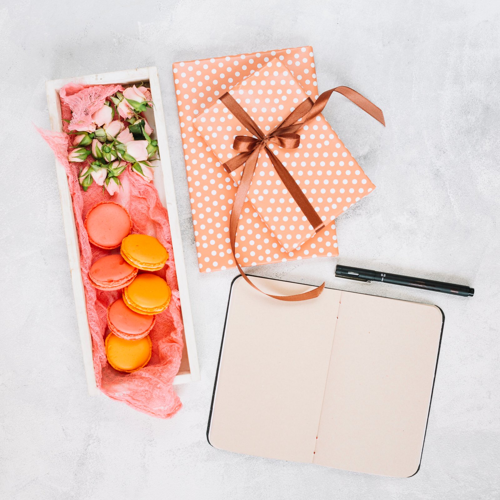 notebook-pen-near-dessert-presents